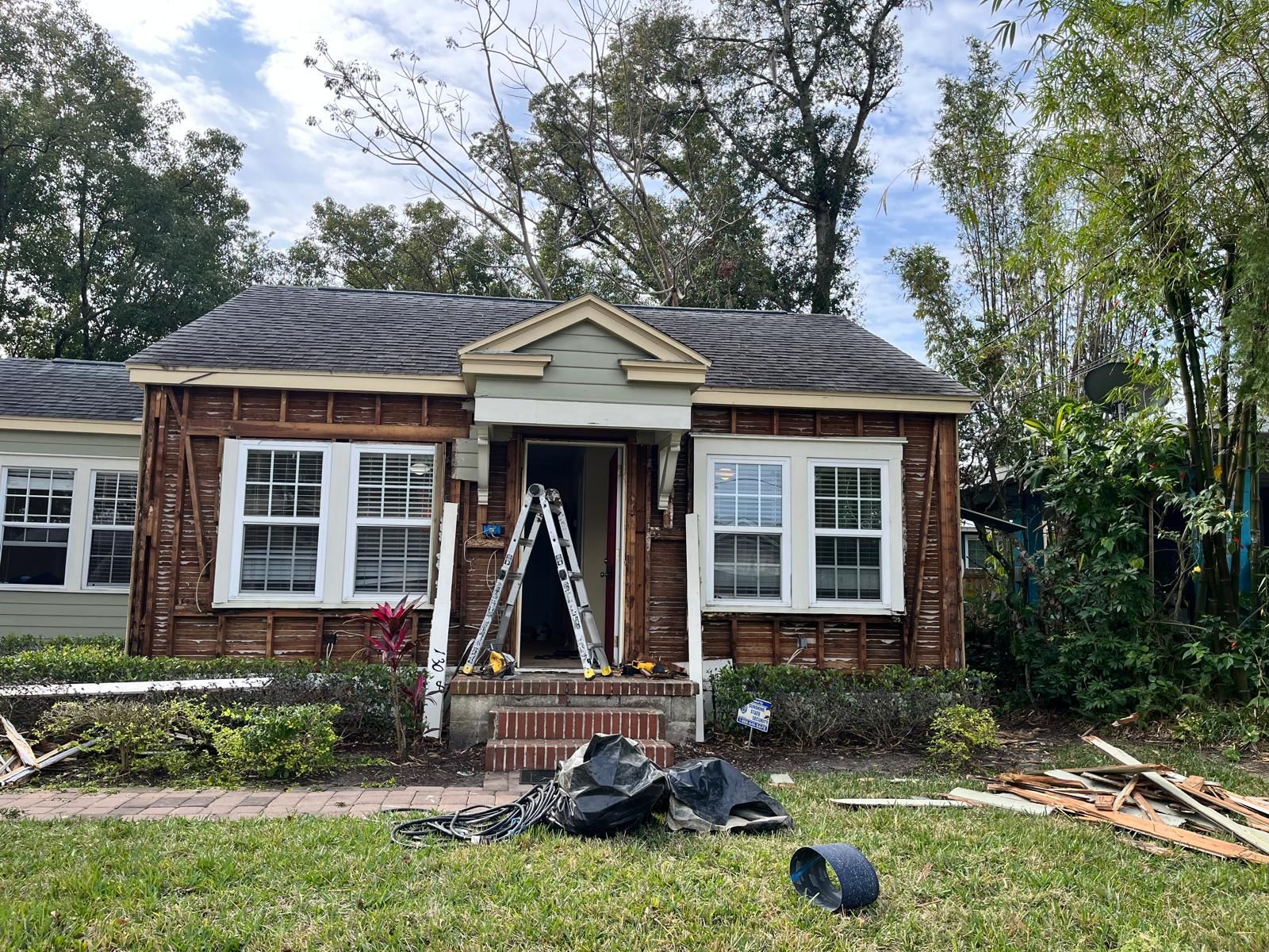 Orlando bungalow being re-sided with new lap siding and trim — photo 9
