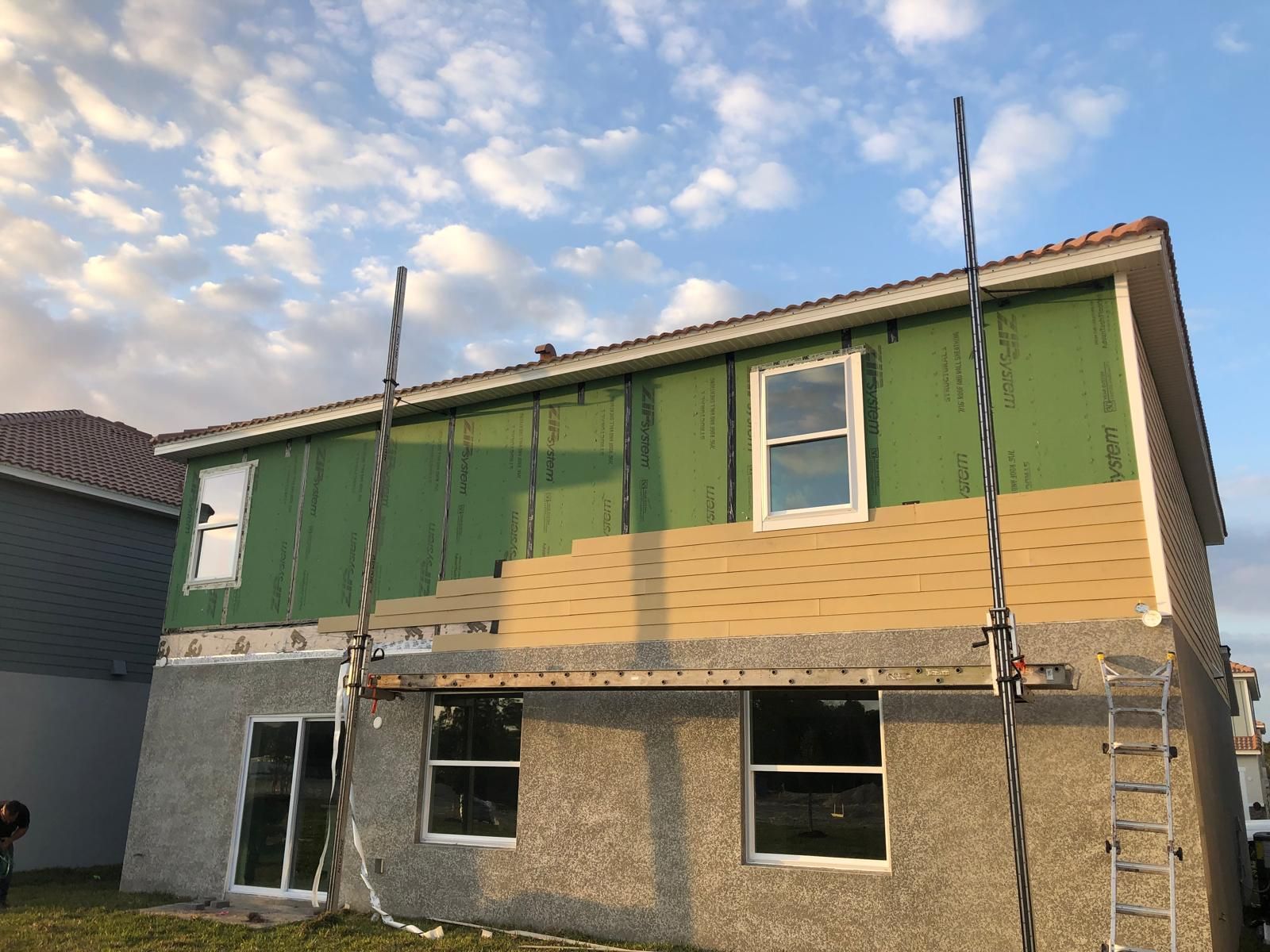 Two-story new construction home with finished exterior siding — photo 2