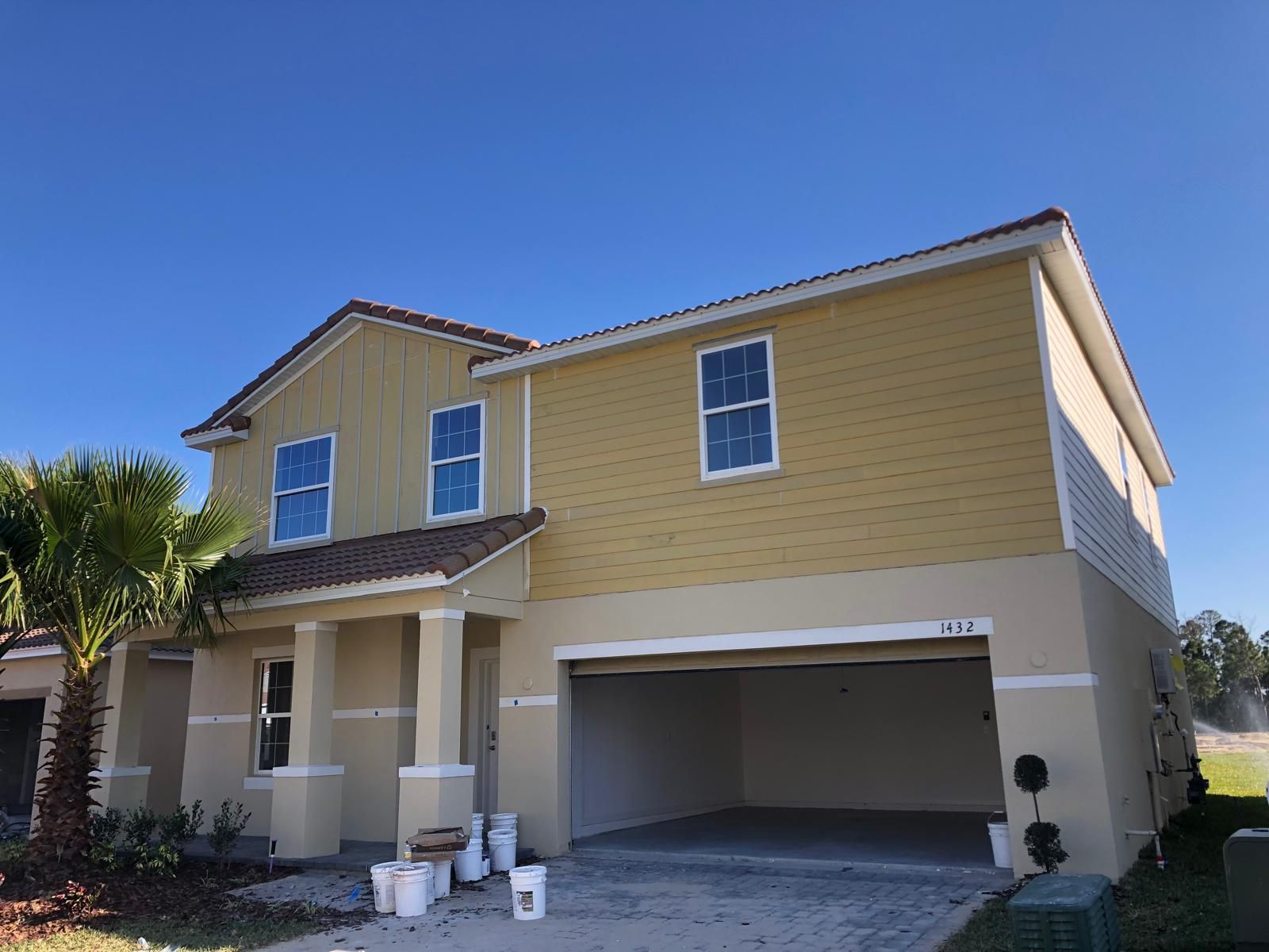 Two-story new construction home with finished exterior siding — photo 3