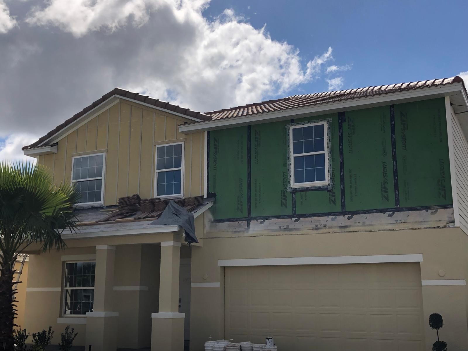 Two-story new construction home with finished exterior siding — photo 4